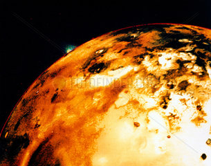 Io  one of the moons of Jupiter  showing a volcanic eruption on the rim  1979.