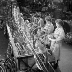 A team of female workers hand balance cycle wheels  British Cycle Company.