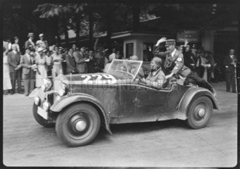 Swastika-wearing men in a motor racing car  Germany  c 1934.