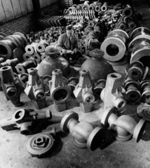 A foundry manager inspects a range of finished castings  1967.