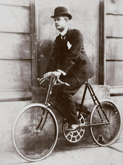 C S Rolls sitting on a bicycle 'geared to 180’  c 1902.