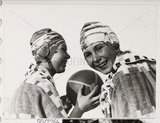 Two girls in swimming caps  c 1930.