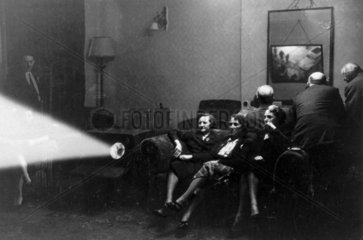 A family watching an early television broadcast  c 1930s.