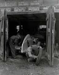 Mechanics working on Caracciola's racing car  1934.