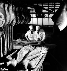 Preparing smoked sides of bacon with apprentice at Marsh and Baxter  1961.
