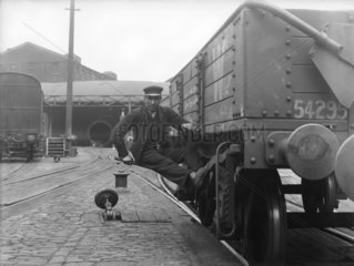 Worker simulating danger at Paddington Station  London  1913.