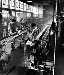 Fitters on shop floor use a chain bench to draw tungsten at Mullards  1955.