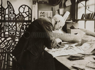 Workman cutting glass for a stained glass window  17 April 1934.