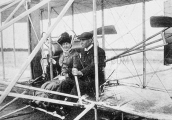 Wilbur Wright and Madame Hart Berg seated in a flying machine  early 1900s.