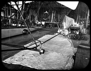Outrigger wheels on Maxim's flying machine during assembly  1894.