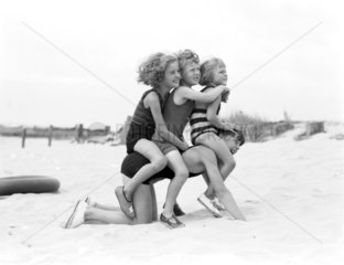 Children playing on the beach  1935.