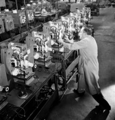 A technician works on row of 35mm cinema projectors  Kershaw  1953.