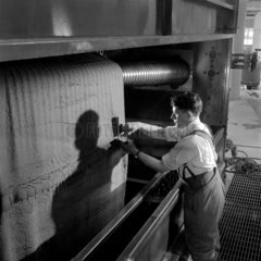 A dyehouse worker sampling a carpet  Kossett Carpets  Brighouse 1956.