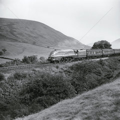 Steam locomotive with carriages  c 1950s.