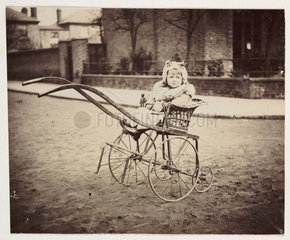 Little girl in a pram  c 1897.