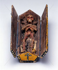 Stylised model of a decomposing corpse in a coffin.