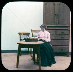 Woman sewing  c 1895.