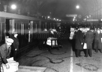 Newspapers being loaded into train vans.
