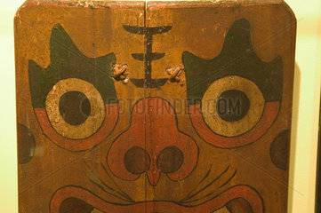 Wooden shield painted with a demon’s face  Chinese  19th century.