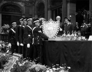 The Duchess of York presenting a shield to paramedics  15 May 1931.