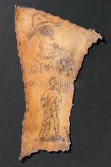Human skin  tattooed with harlequin and figure of Samson  French  1830-1900.