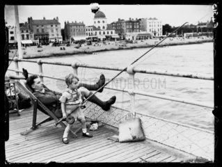 Child fishing on the pier  29 July 1937.