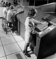Female workers feed football coupons in to automatic recognition computer  1970.