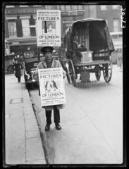 Man carrying a sandwich board  London  1935.