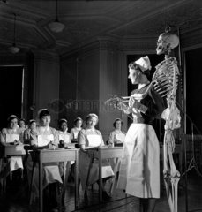 Nurse uses skeleton to teach anatomy at Royal Free Hospital class  1952