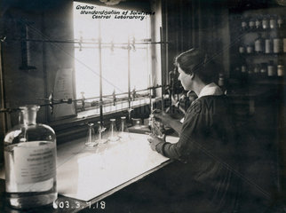 Woman worker in laboratory at Gretna munitions factory  Scotland  1918.