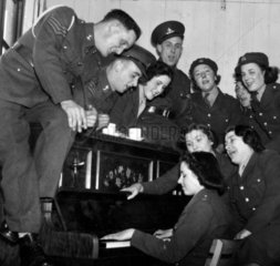 Soldiers and ATS girls at the piano  Fort Crosby  March 1940.