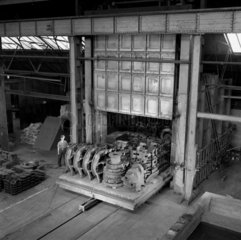 Elevated long shot of figure with the new annealing furnace  Burton  1957.