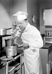 Chef tasting from a saucepan  1949.