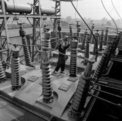 Engineer checks large transformers before despatch   English Electric  1960