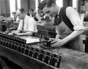 Production line worker assembling a Kodak c