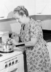 Woman frying eggs  1950.