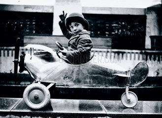 Boy sitting in a toy aeroplane  Selfridges  London  18 December  1931.