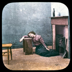 Drunken woman on floor in front of fireplace  c 1895.