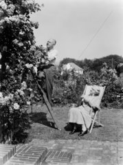 Elderly couple relaxing in the garden  1956.