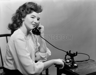 Woman using the telephone  c 1950.