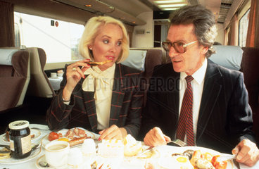 Business people having breakfast on a train  c 1980s.