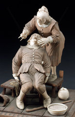 Wood and ivory figure group depicting a tooth extraction  17th century?