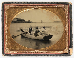 Family in a boat  c 1865.