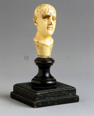 Ivory phrenological head with wooden circular pedestal  1850-1914.