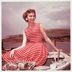 Woman wearing a summer dress  c 1950s.
