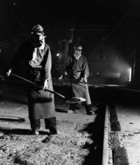 Two steel men with shovels near open hearth furnace  United Steel  1948.