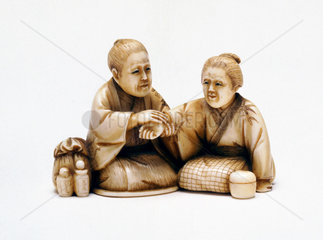 Netsuke showing a doctor and patient  Japanese  late 19th century.
