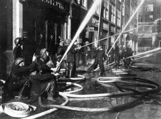 Firemen fighting a blaze caused by an air r