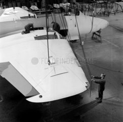 Men work on wing of Canberra aircraft  English Electric Preston  1956.
