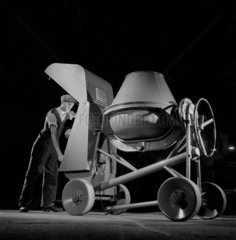 Production worker with completed cement mixer  Rochester  1959.